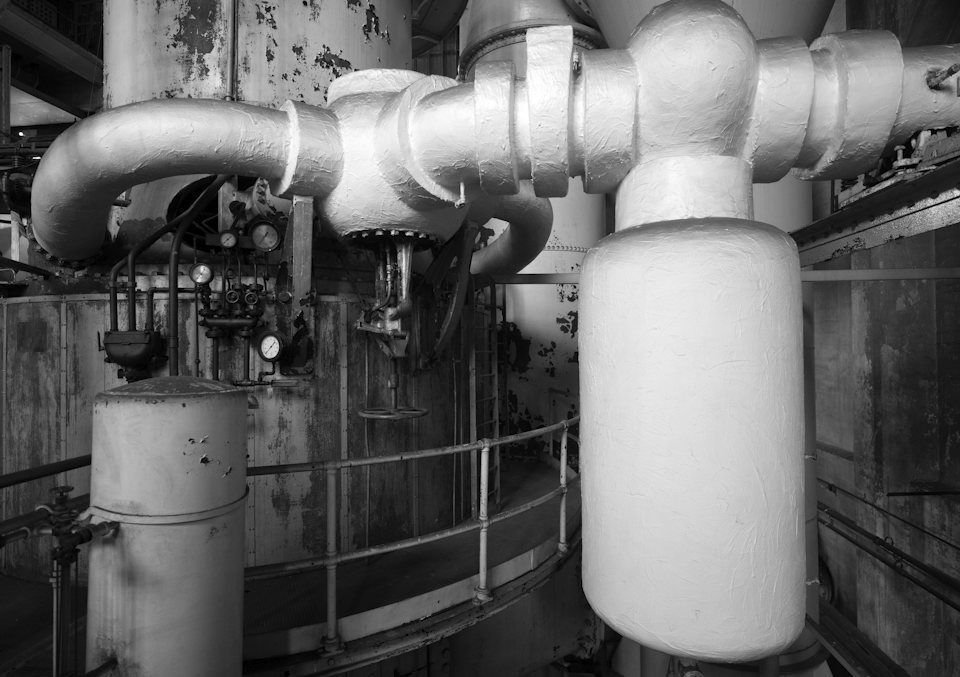 Insulated pipework and pumps in a commercial plant room